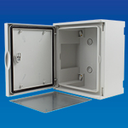 Photograph of an open polyester wall mounted enclosure with metal backplate in front